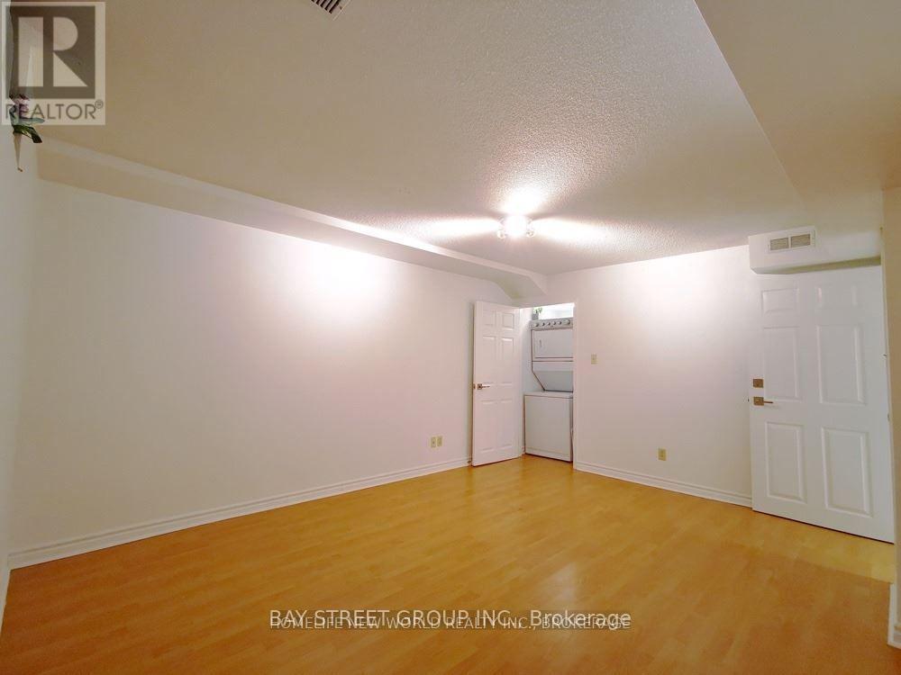 A room with a white ceiling and wooden floor.