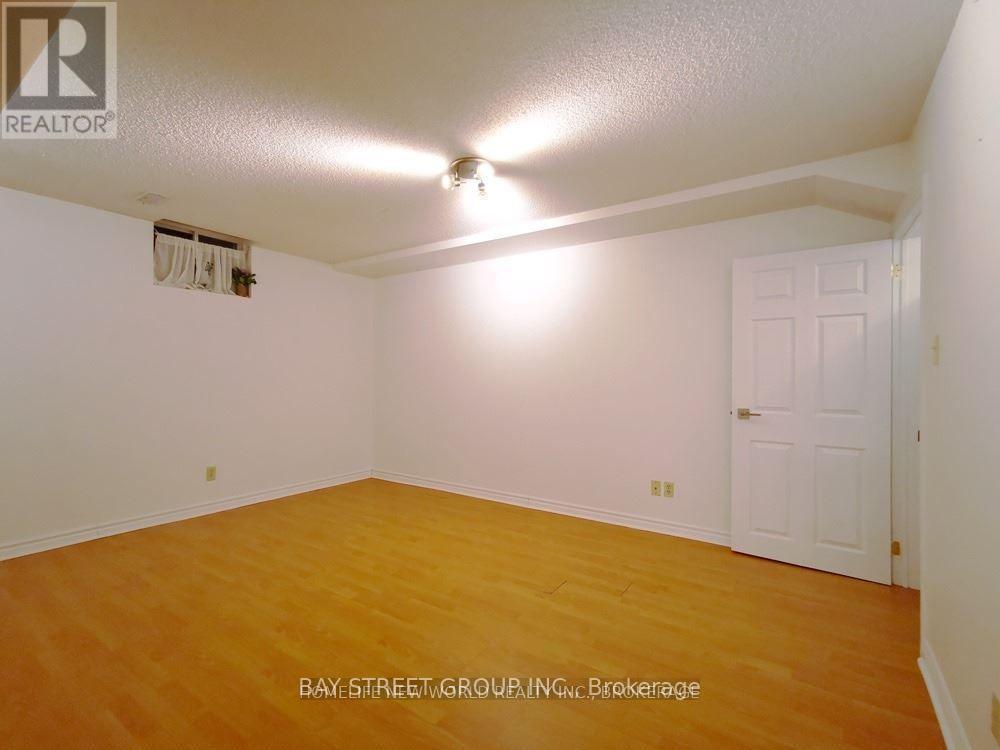 A room with a white door and a ceiling fan.