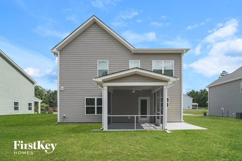A house with a porch and a covered entrance is for sale by FirstKey Homes.
