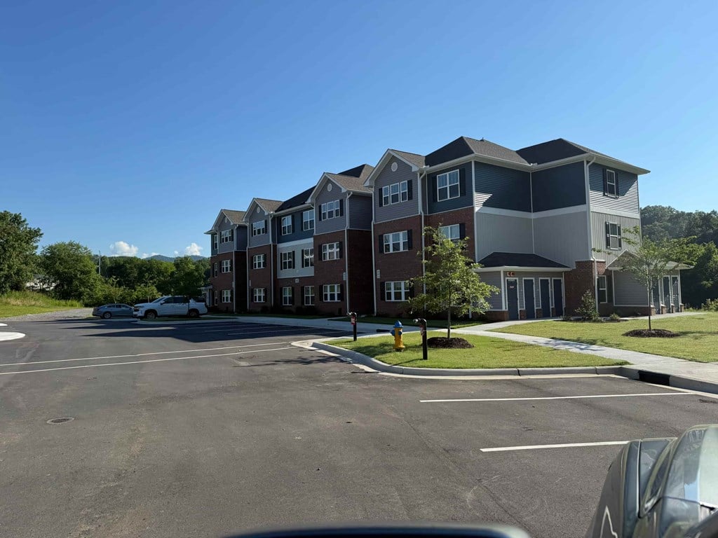 A large building with a parking lot in front of it.