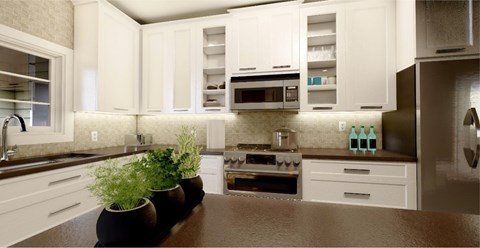 A kitchen with white cabinets and a brown countertop.