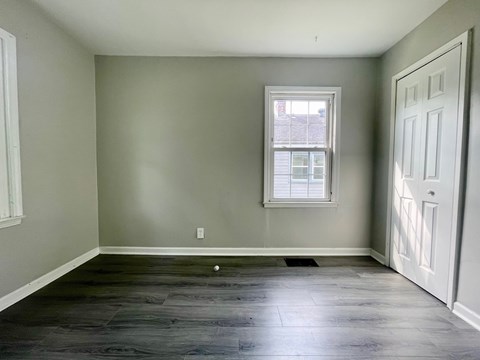 A room with a window and a door.