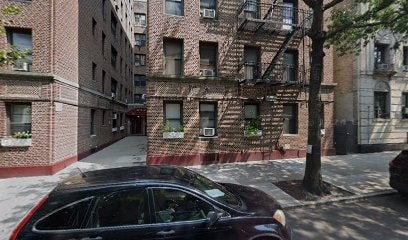 A black car is parked on the side of a street.