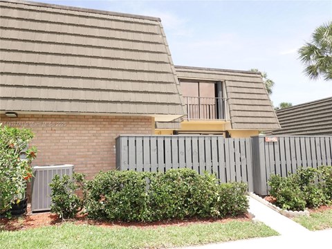 A house with a grey roof and a grey fence.