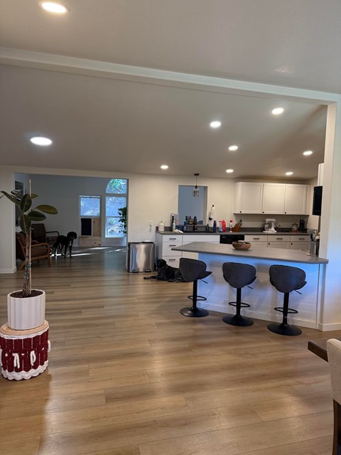 A kitchen with a table and chairs in front of it.