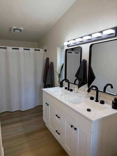 A bathroom with a white sink and a white cabinet.