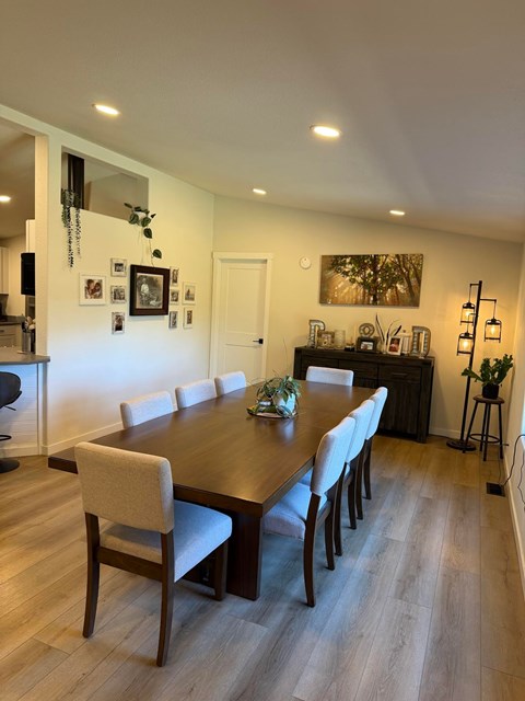 A dining room with a long table and chairs.