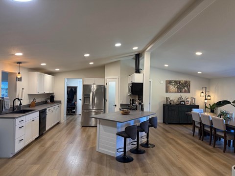 A modern kitchen with a dining area and a large island.