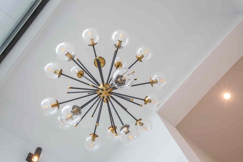 A chandelier with multiple bulbs is hanging from the ceiling.