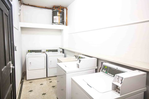 A white washing machine and dryer in a small laundry room.