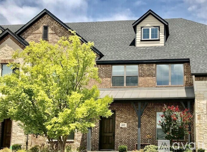 A house with a tree in front of it.
