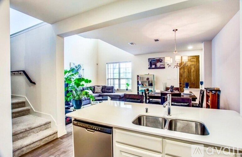 A modern kitchen with a stainless steel dishwasher and a white countertop.