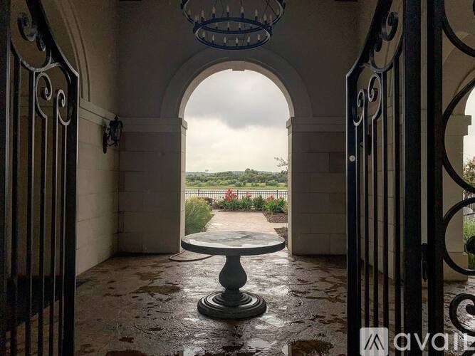 A view through an archway looking out to a garden.