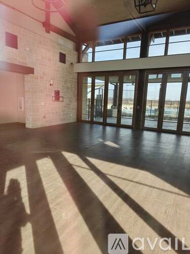 A room with a large window and a fireplace.