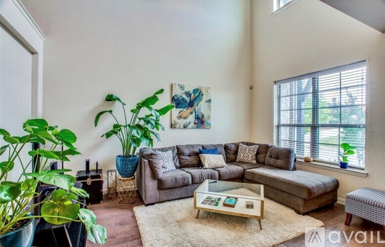 A living room with a grey couch and a coffee table.