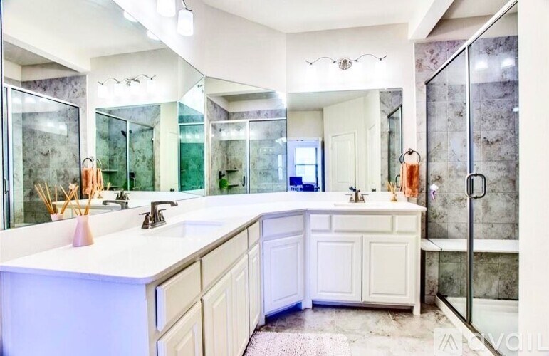 A large, modern bathroom with a double sink vanity and a walk-in shower.