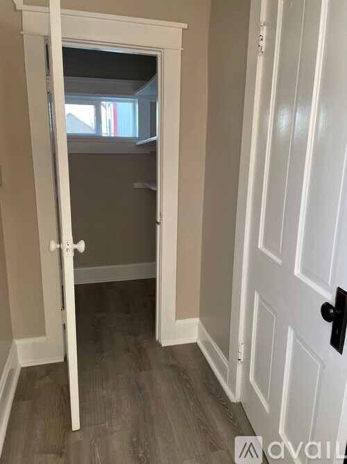 A white door with a black handle is closed.