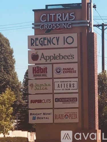 A sign for Citrus Crossing with many businesses listed.