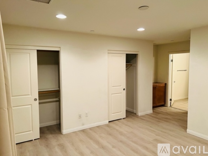 A bedroom with a bed, desk, and chair.