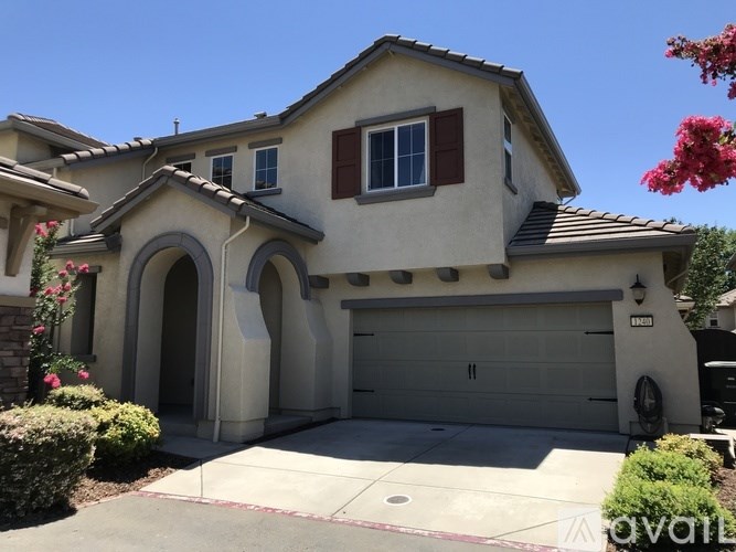 A house with a garage and a driveway.