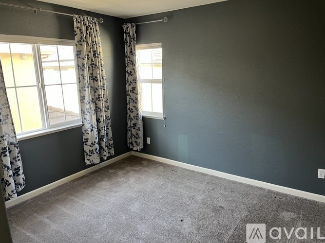 A room with grey walls and a carpeted floor.