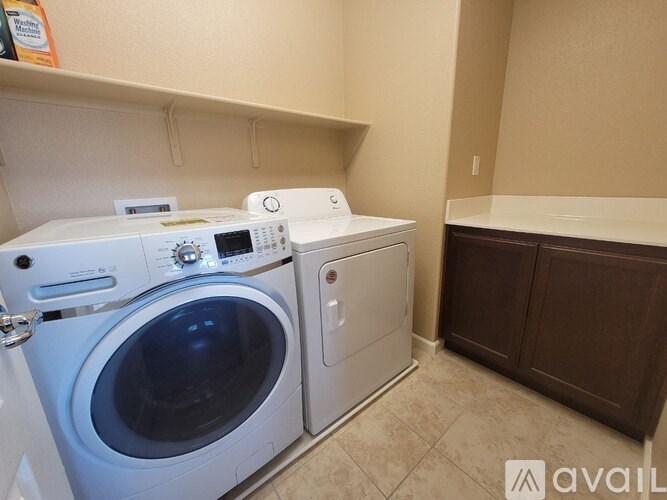 A white washing machine and dryer in a small laundry room.