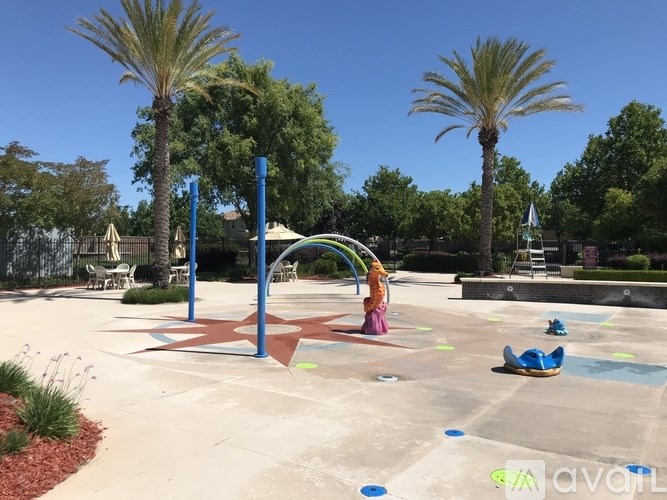 A playground with a star-shaped structure and a child playing on it.