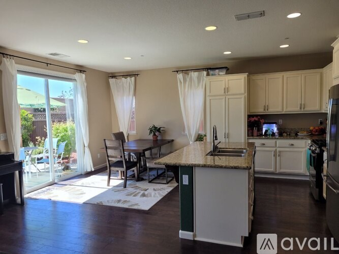 A kitchen with a dining table and chairs is available for rent.
