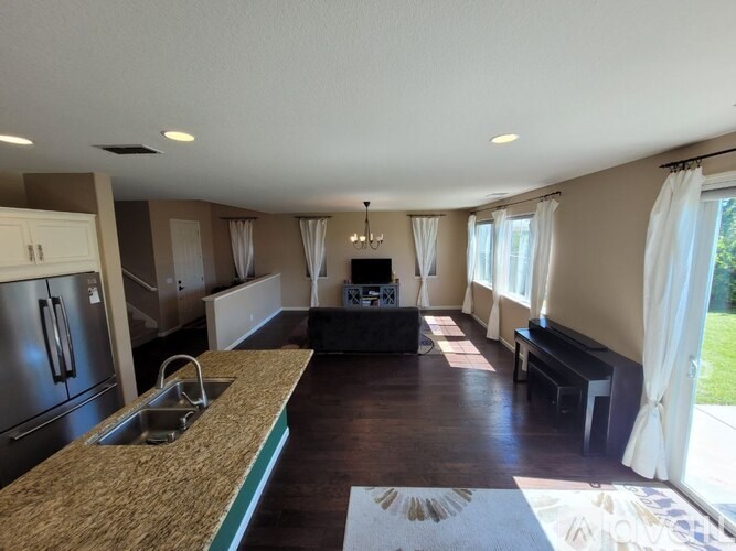 A kitchen with a sink and a counter top.