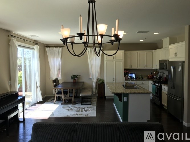 A modern kitchen with a dining table and chairs.
