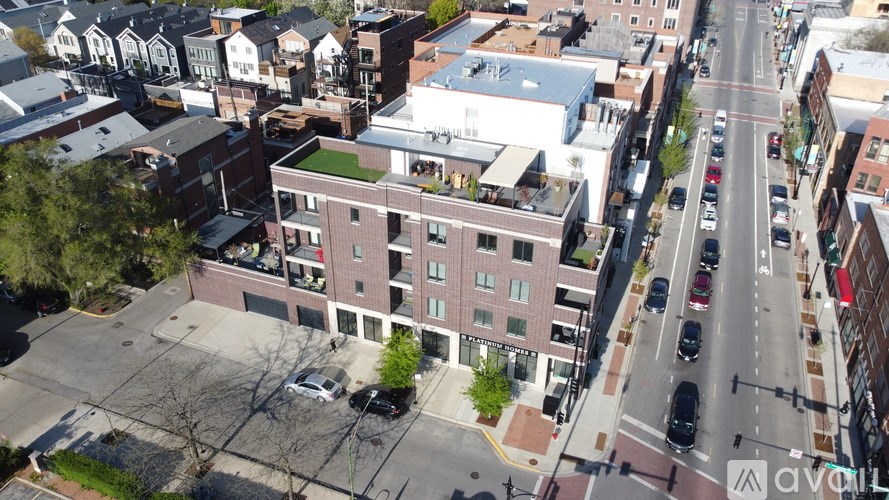 A street view of a city with buildings and cars.