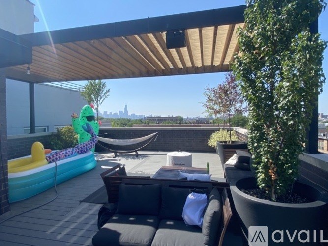 A sunny patio with a hammock and a pool.