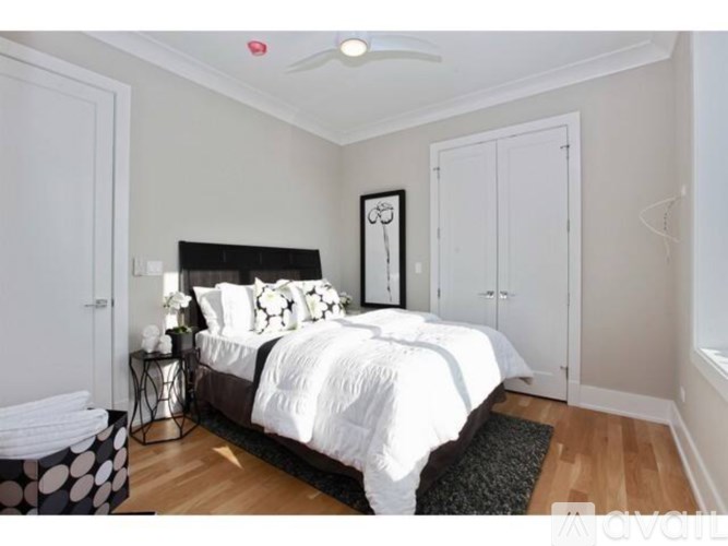 A bedroom with a large bed and a ceiling fan.