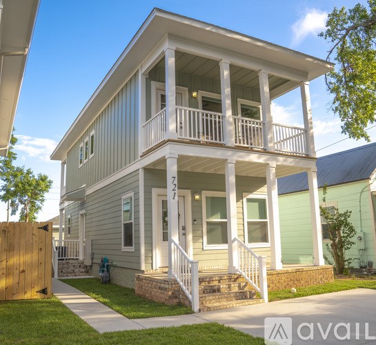 A two-story house with a balcony on the second floor.