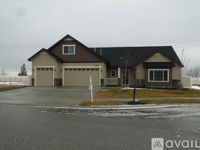 A house with a garage and a driveway in front of it.