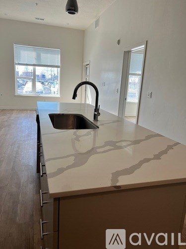A kitchen with a sink and a window.