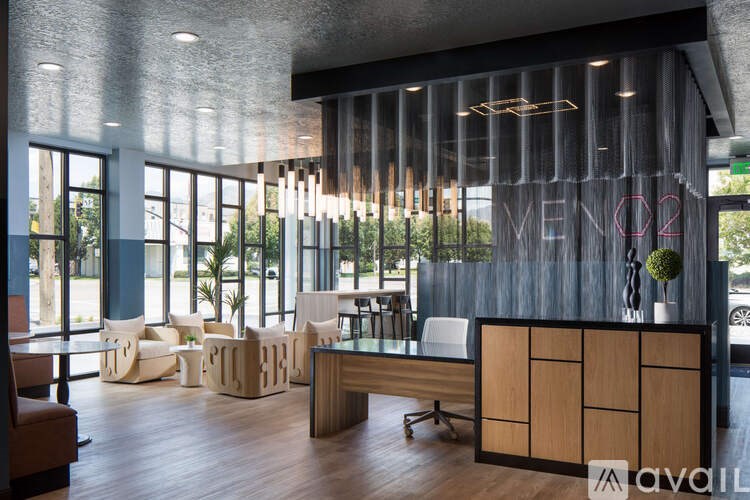 A modern office lobby with a reception desk and seating area.