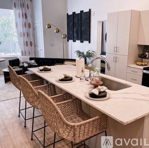 A kitchen with a long table and chairs.