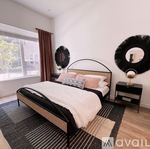 A bedroom with a large bed and a mirror on the wall.