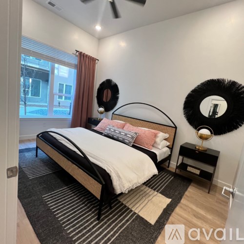 A bedroom with a large bed and a mirror on the wall.