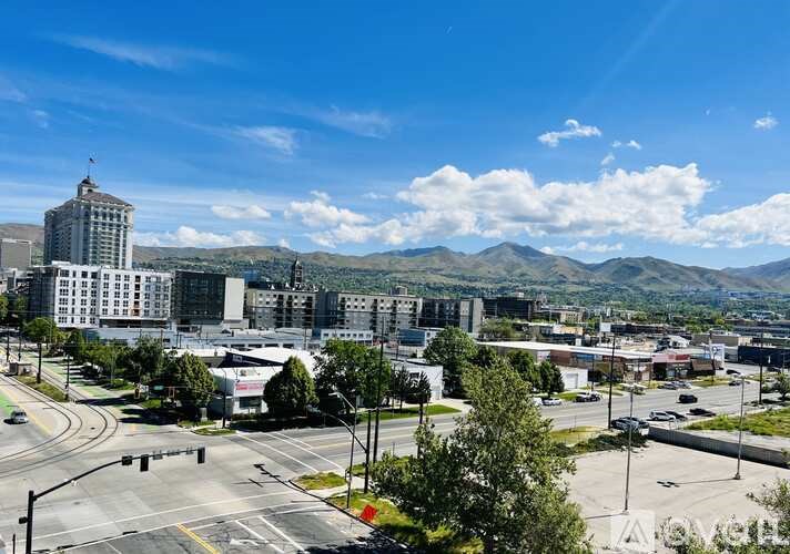 A cityscape with a mountain range in the background.