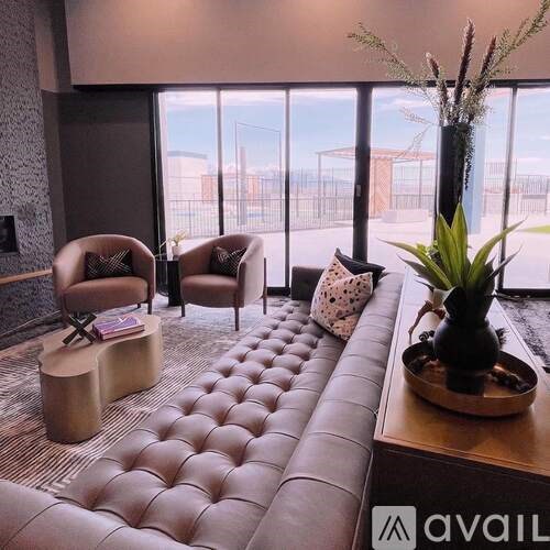 A living room with a large window and a view of a construction site.