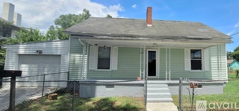 A small house with a garage is for sale.
