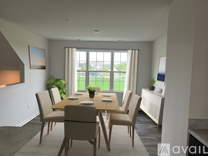 A dining room with a wooden table and chairs.