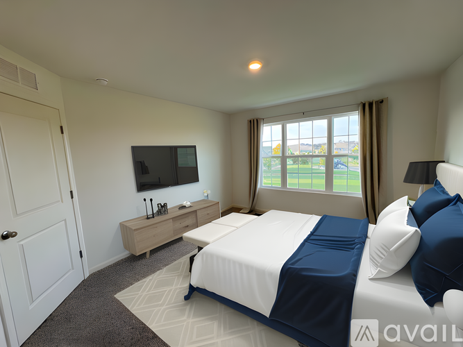 A bedroom with a large bed and a flat screen TV.