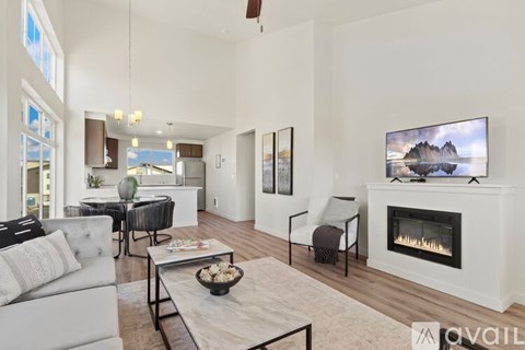 A living room with a fireplace and a painting on the wall.