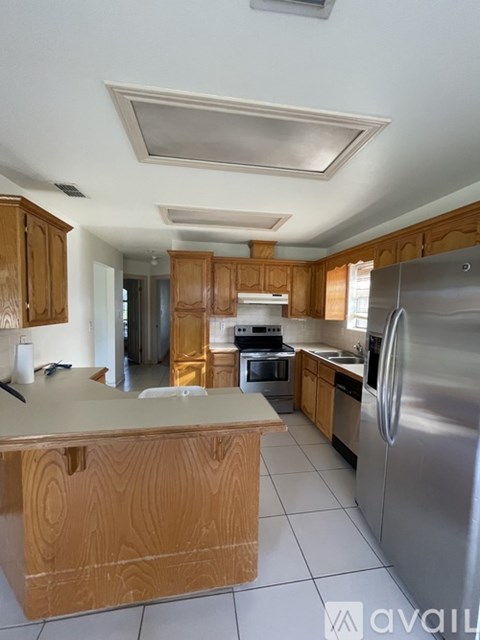 A kitchen with wooden cabinets and stainless steel appliances.