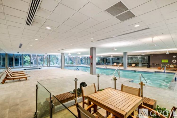 A large indoor swimming pool with a table and chairs.