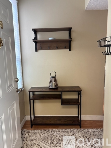 A bedroom with a bed, nightstand, and a ceiling fan.