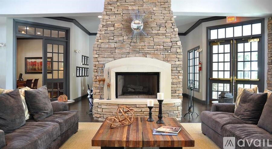 A living room with a stone fireplace and a couch.